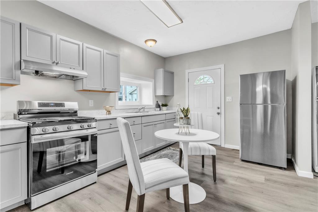 305 1/2 East Lutton Street New Castle, PA 16101 - Photo 6 of 39 a kitchen with stainless steel appliances a stove a sink dishwasher and a refrigerator