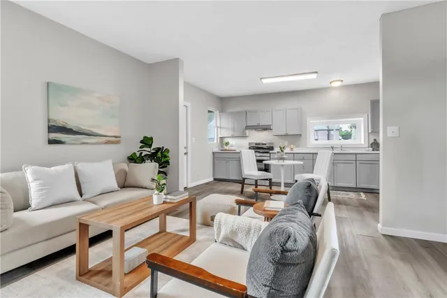 a living room with furniture and a kitchen