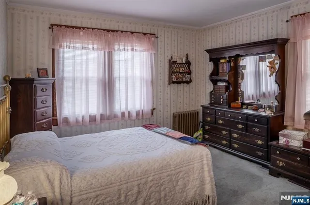 a bedroom with a bed and a mirror