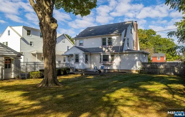 a front view of a house with a yard table and chairs