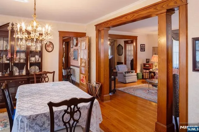 a view of a dining room with furniture and chandelier