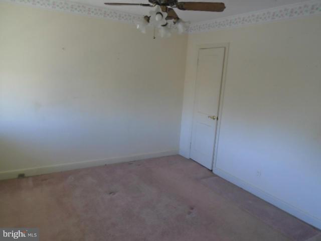 104 Wiltshire Road Baltimore, MD 21221 - Photo 6 of 13 a view of a room with a fan