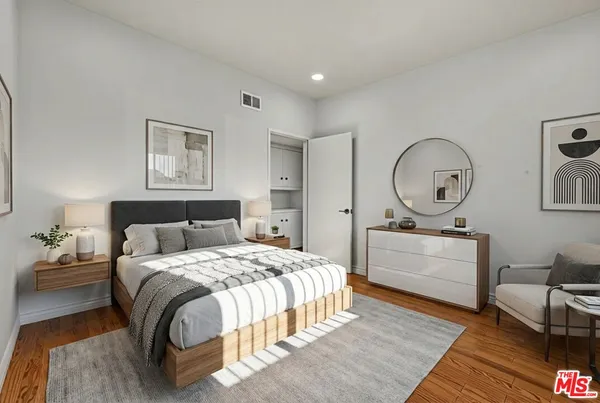 a bedroom with a bed and a dresser