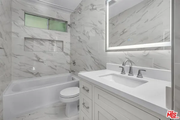 a bathroom with a sink a toilet and a bathtub