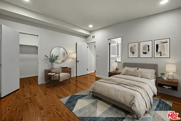 a bedroom with a bed and a mirror