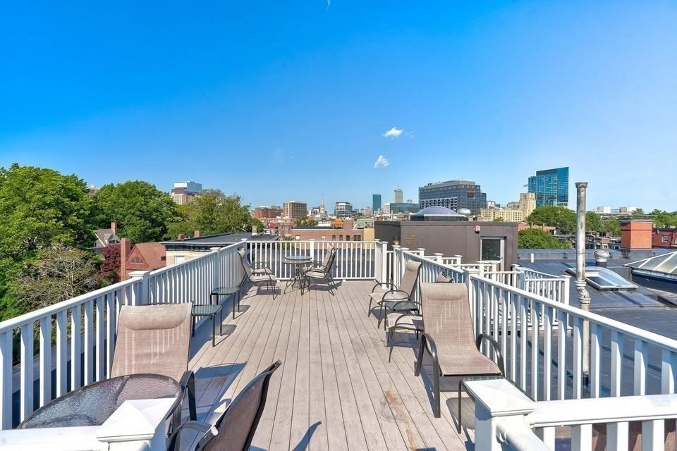 1064 Beacon Street, Unit 9 Brookline, MA 02446 - Photo 16 of 19 a view of a balcony with wooden floor and fence