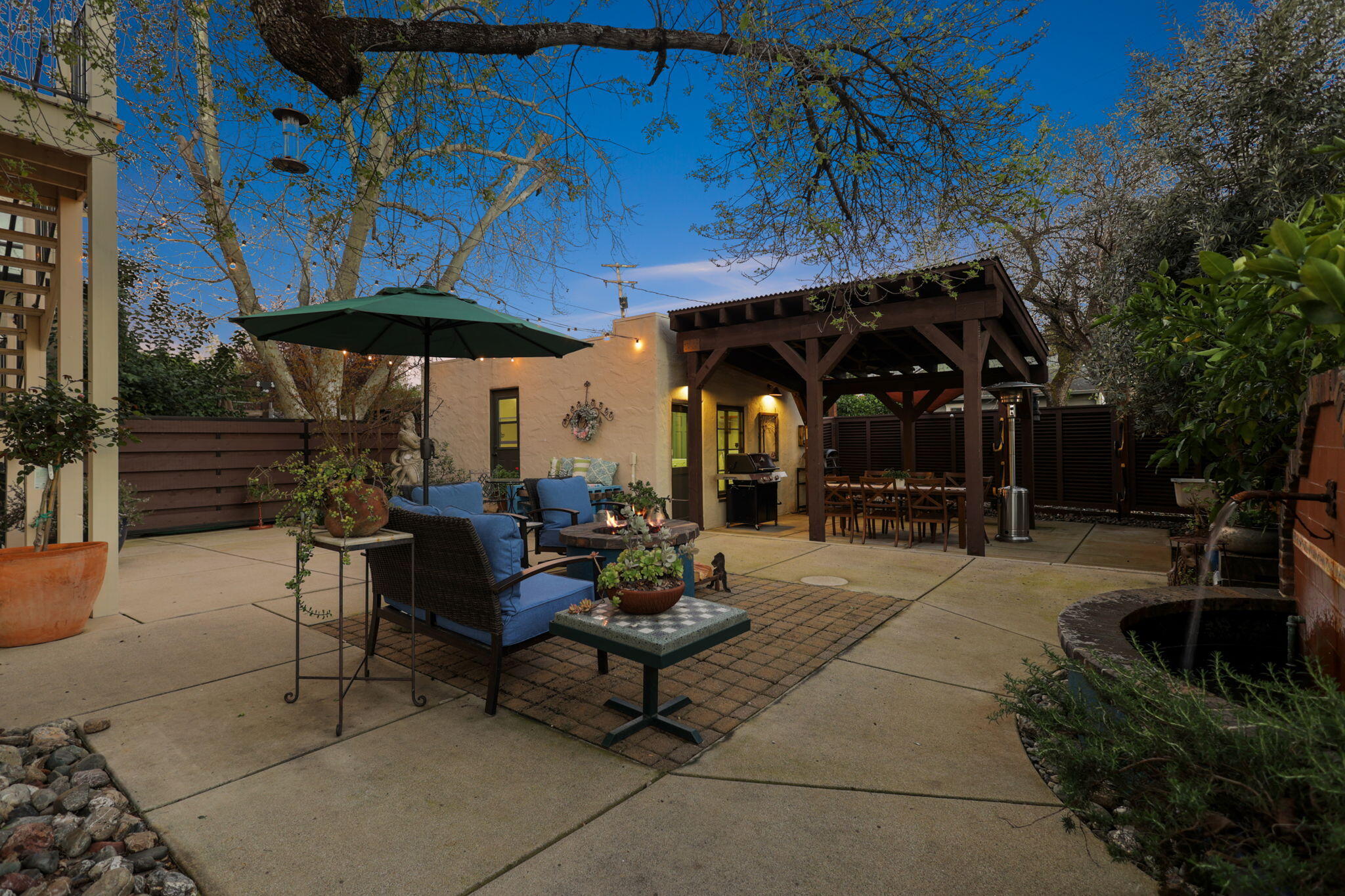 1465 Riverside Drive Redding, CA 96001 - Photo 7 of 163 a view of a patio with a table and chairs under an umbrella