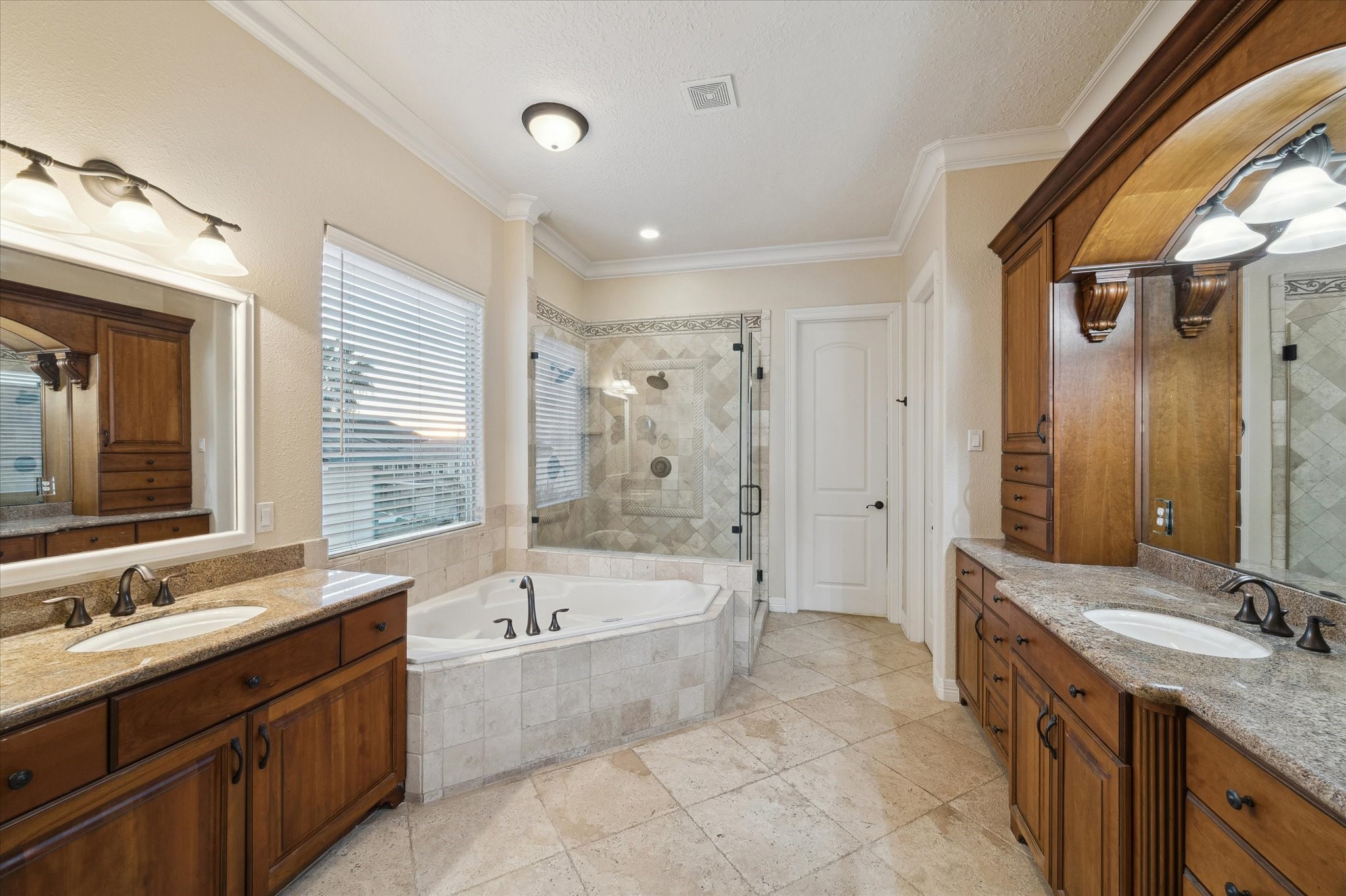 1406 Todville Road Seabrook, TX 77586 - Photo 36 of 50 CUSTOM VANITIES WITH GRANITE COUNTERS, AN AIR JETTED TUB AND WALK-IN SHOWER FINISH OFF THE PRIMARY BATH.