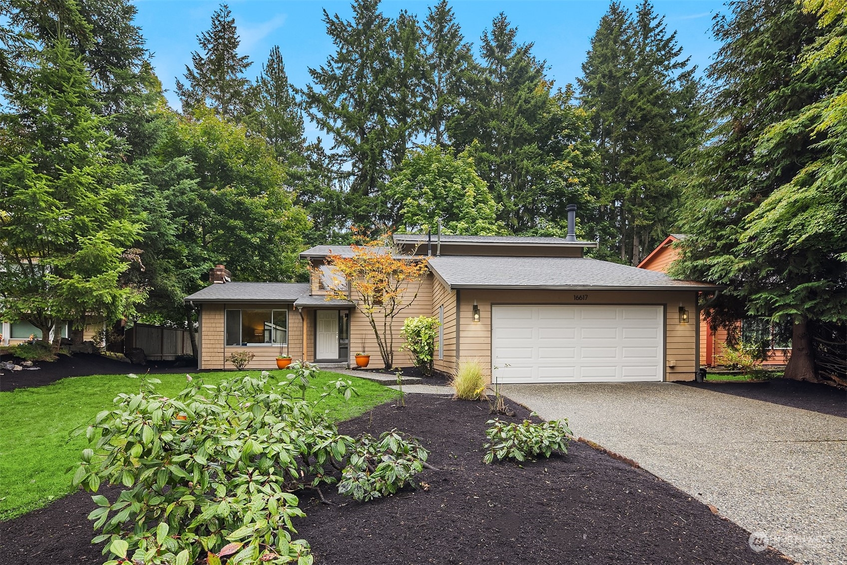 a front view of a house with a garden