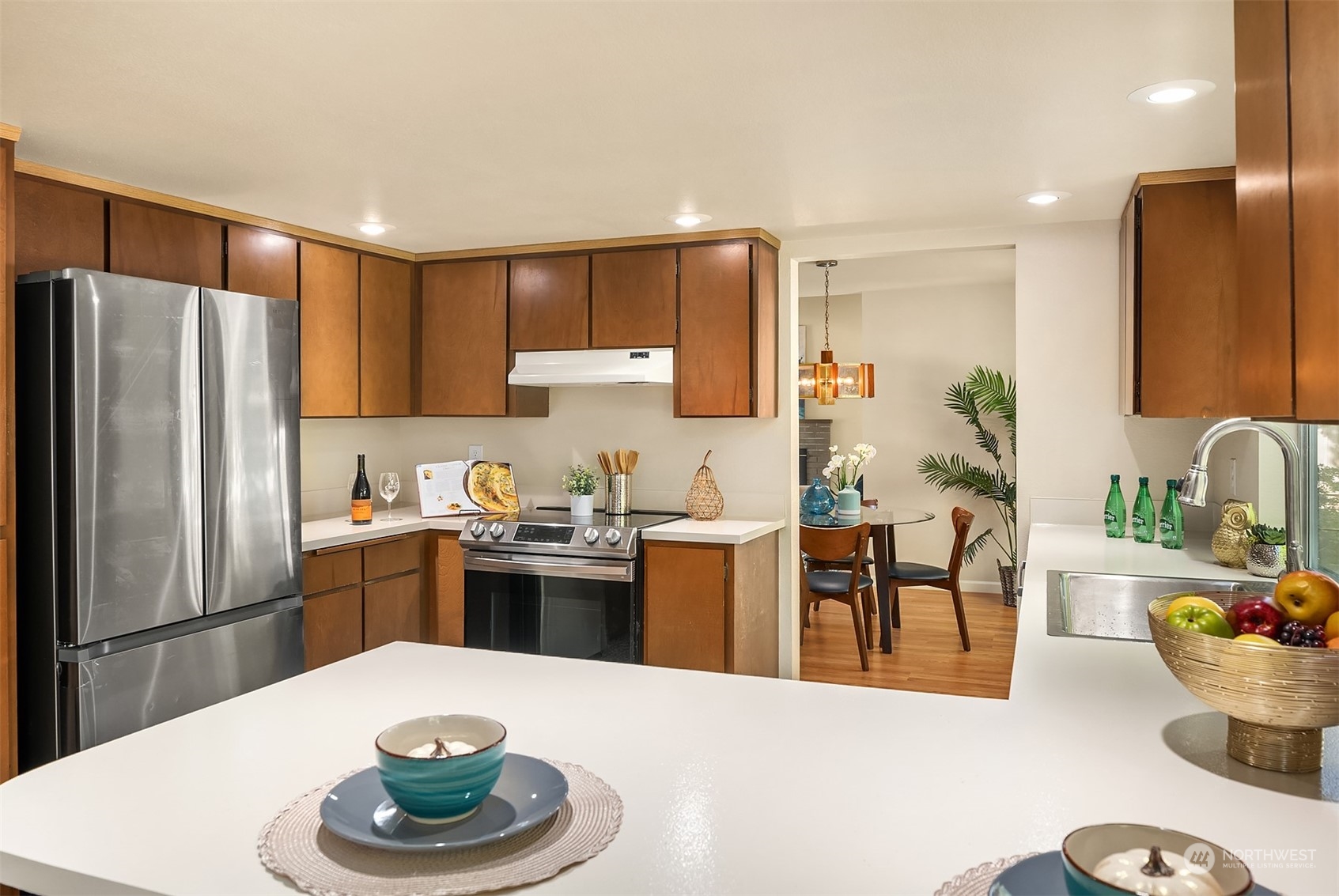 16617 24th Drive Southeast Bothell, WA 98012 - Photo 10 of 29 a kitchen with stainless steel appliances kitchen island granite countertop a dining table and chairs