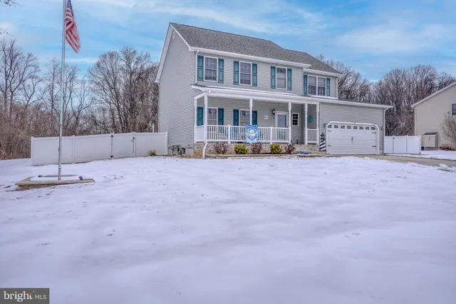 a view of a building with a snow in the yard