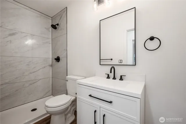 a bathroom with a sink toilet and shower