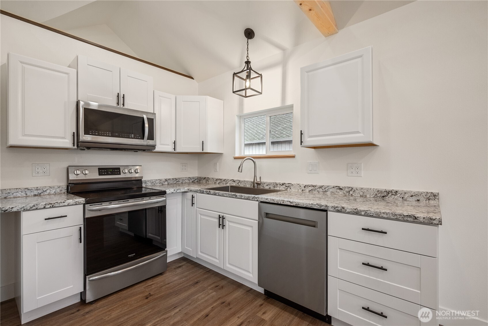 450 16th Avenue Longview, WA 98632 - Photo 8 of 23 a kitchen with granite countertop white cabinets stainless steel appliances and a sink