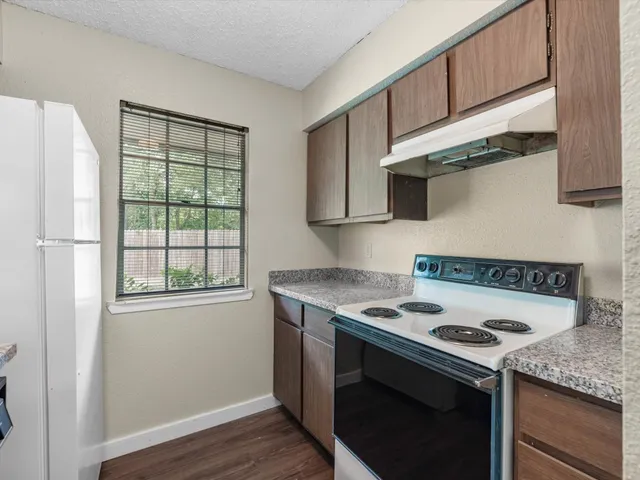 a kitchen with stainless steel appliances granite countertop a sink stove and microwave