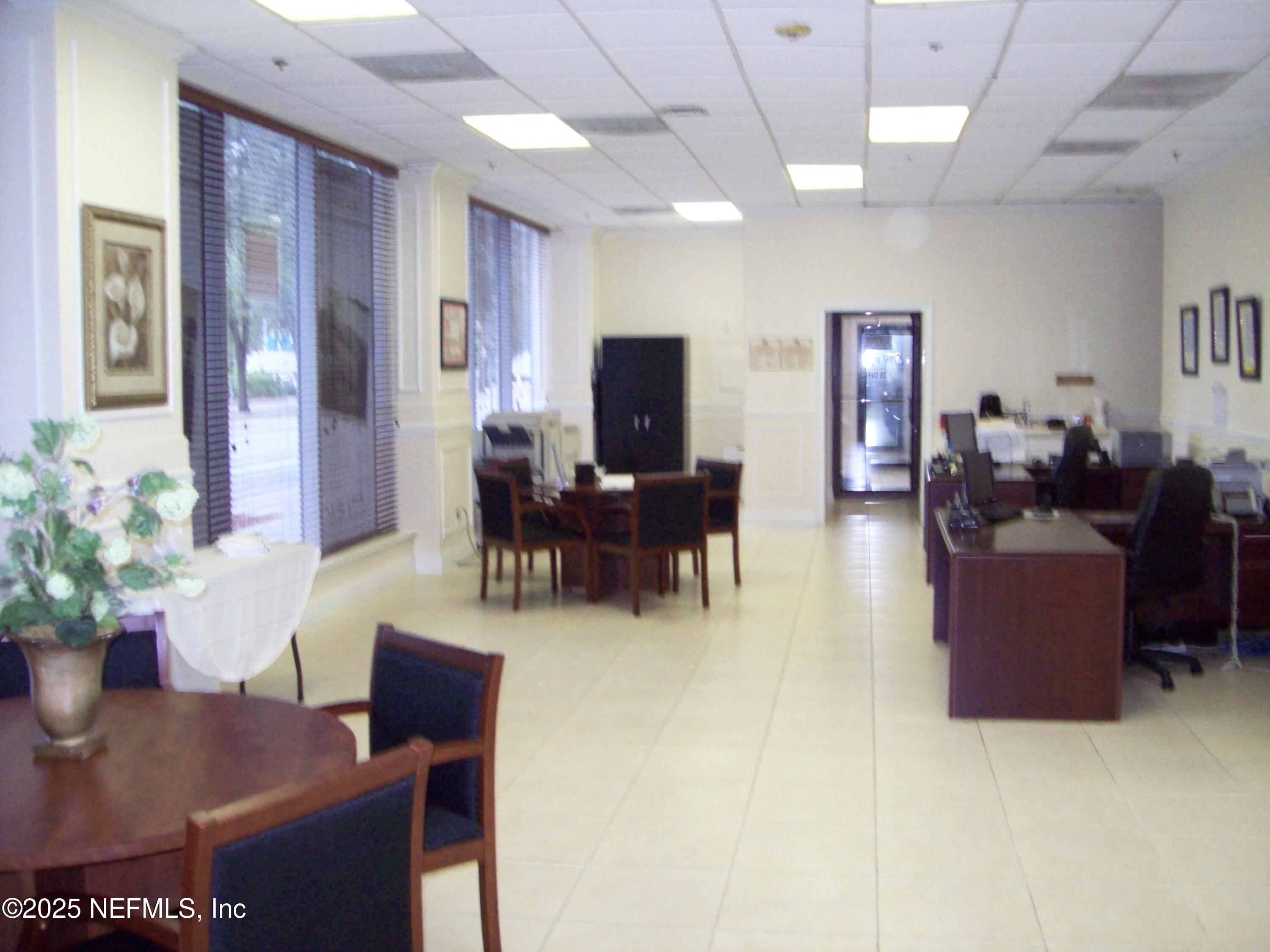 311 West Ashley Street, Unit 4 Jacksonville, FL 32202 - Photo 2 of 14 a living room with furniture potted plant and a flat screen tv