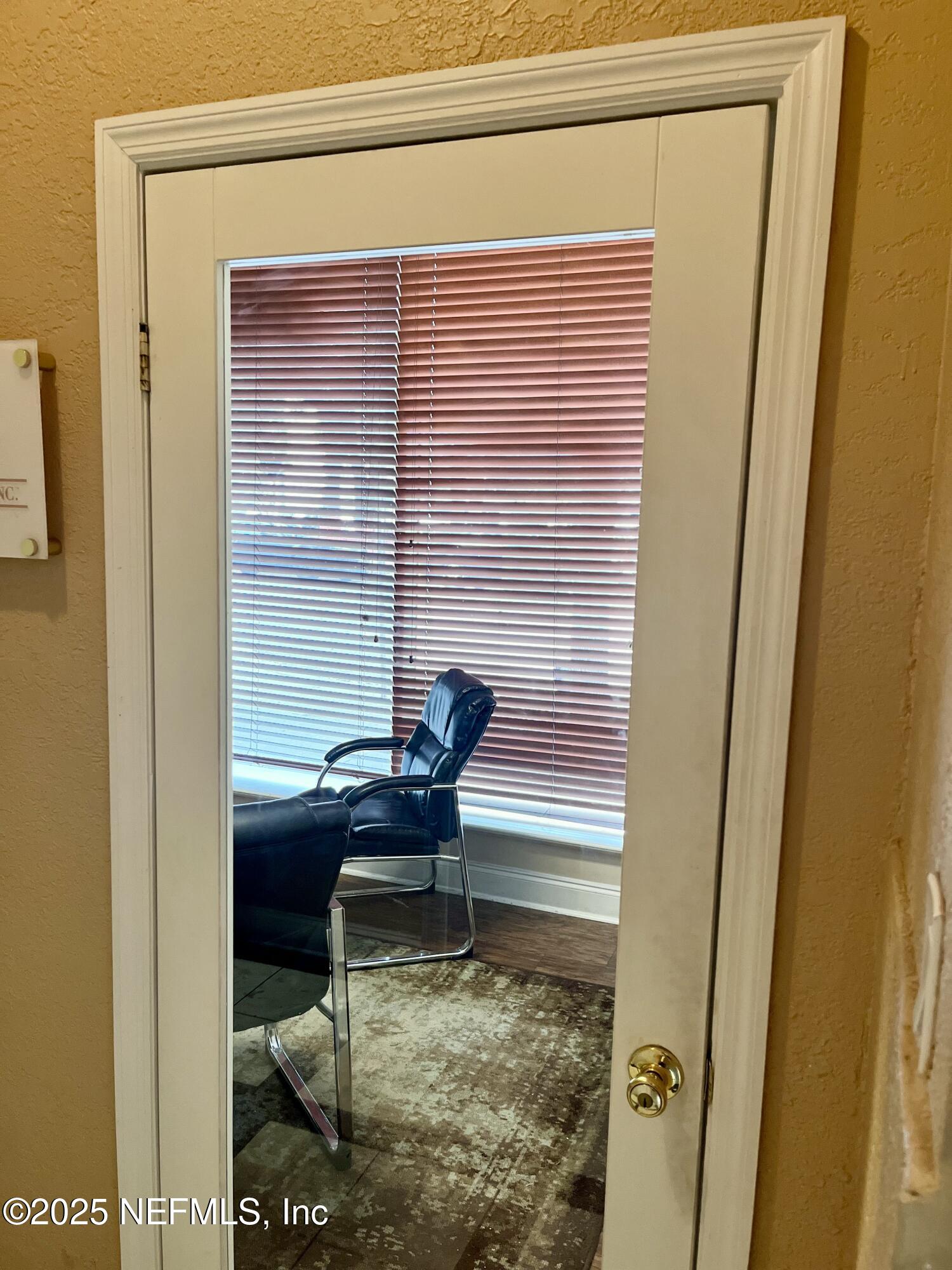 311 West Ashley Street, Unit 4 Jacksonville, FL 32202 - Photo 6 of 14 a view of a door and chair in a balcony