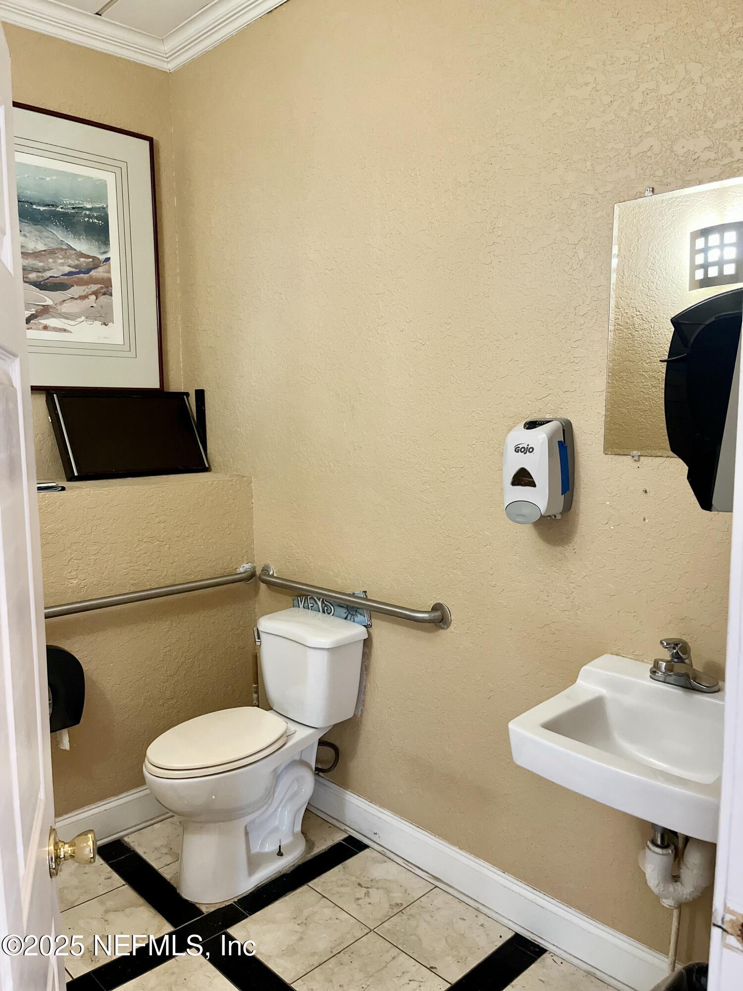 311 West Ashley Street, Unit 4 Jacksonville, FL 32202 - Photo 9 of 14 a white toilet sitting next to a bathroom sink