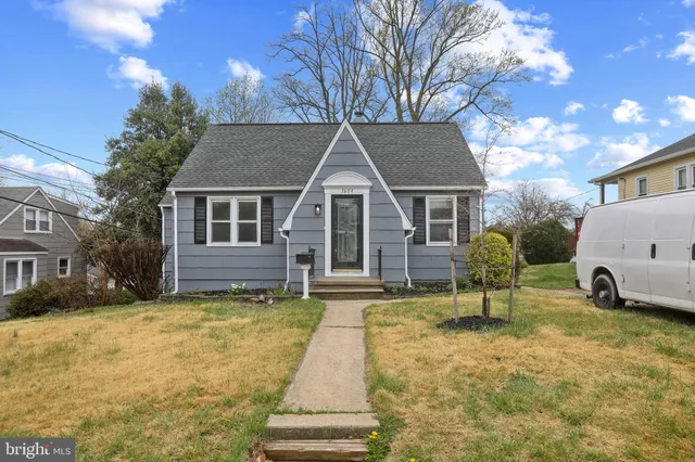 a view of a house with a yard covered in snow