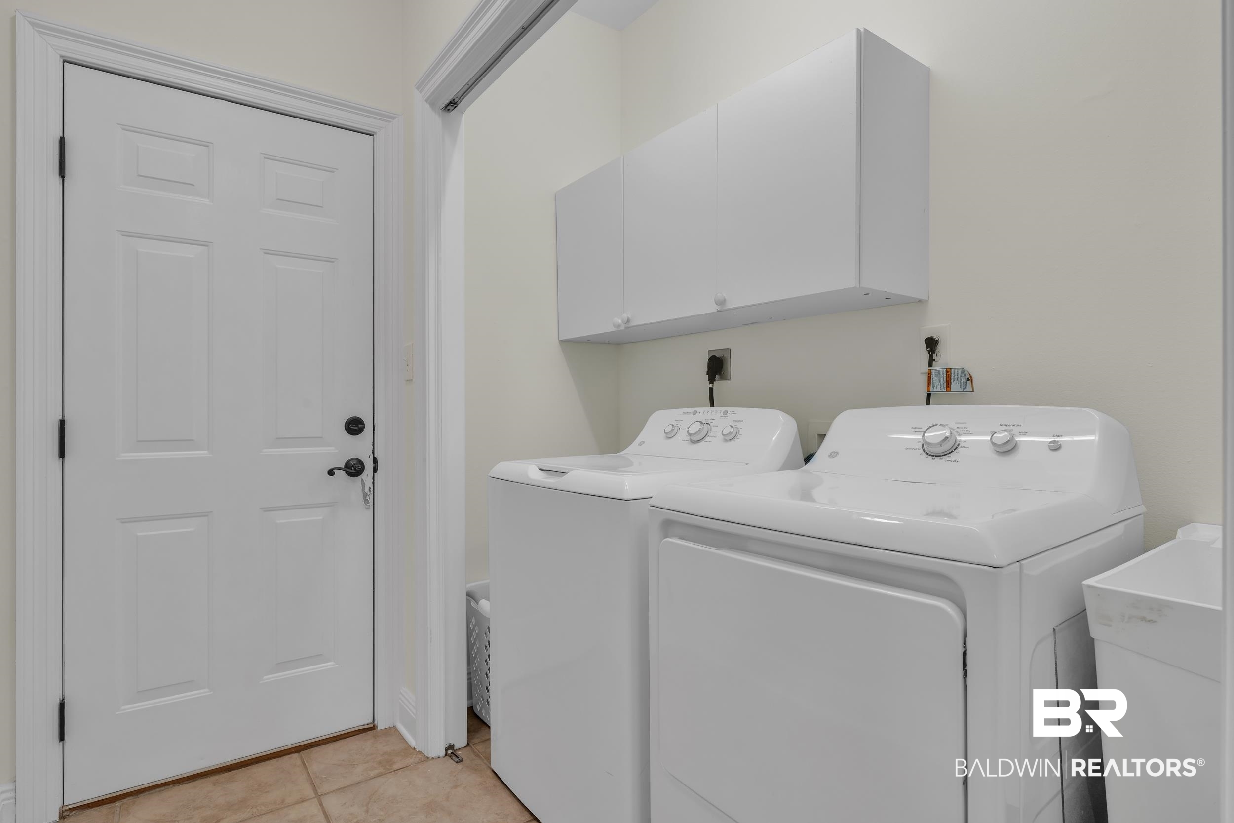 4606 Osprey Drive Orange Beach, AL 36561 - Photo 40 of 44 Hall Laundry area featuring cabinet space, washing machine dryer and sink.