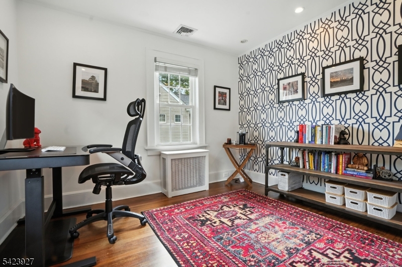 127 Green Village Road Madison, NJ 07940 - Photo 12 of 16 a view of a workspace with furniture and a book shelf