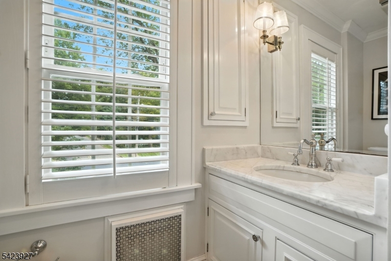 127 Green Village Road Madison, NJ 07940 - Photo 13 of 16 a bathroom with a sink a vanity and a next to a window