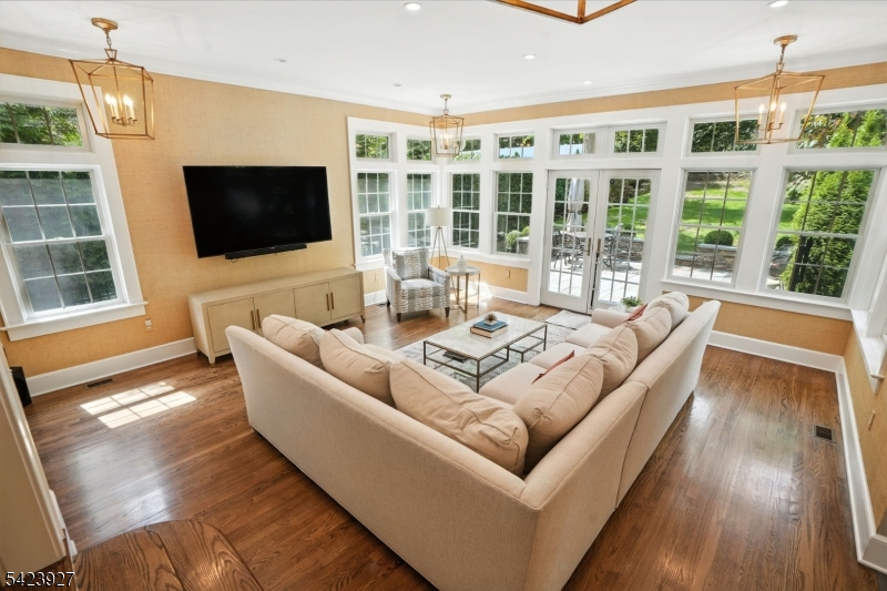 127 Green Village Road Madison, NJ 07940 - Photo 5 of 16 a living room with furniture a flat screen tv and a floor to ceiling window