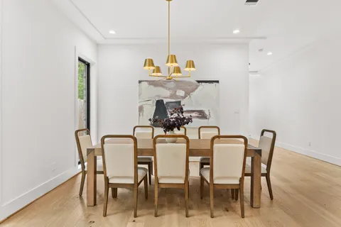 a dining room with furniture and wooden floor