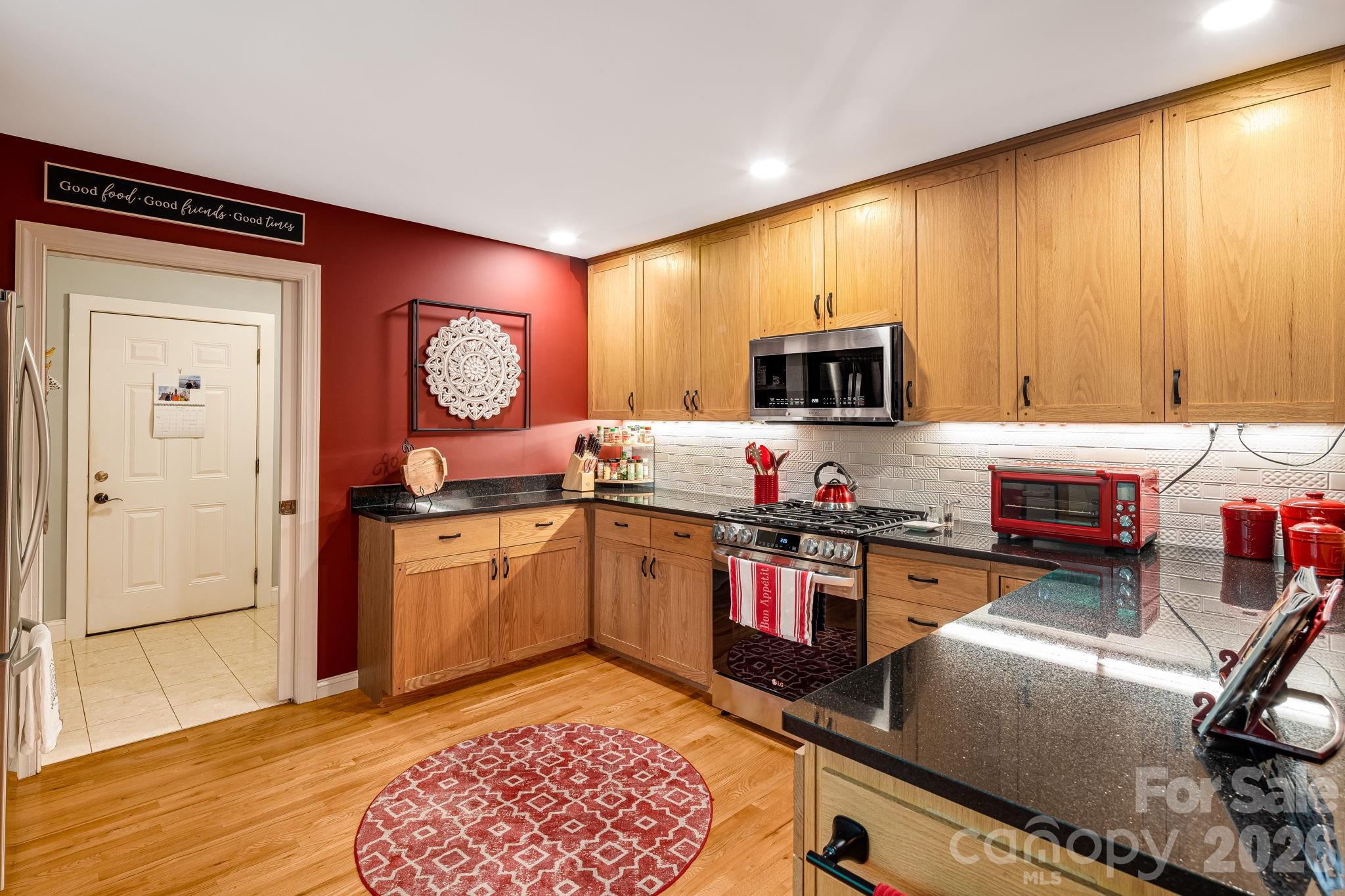 5584 Spring Road Hendersonville, NC 28739 - Photo 16 of 45 a kitchen with a refrigerator and a stove top oven