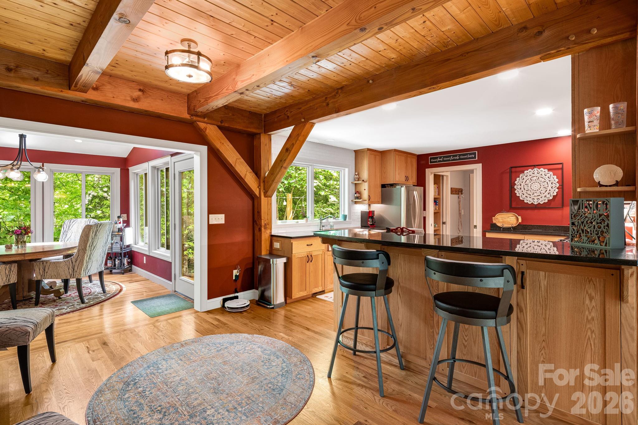 5584 Spring Road Hendersonville, NC 28739 - Photo 20 of 45 a living room with furniture a flat screen tv and a large window