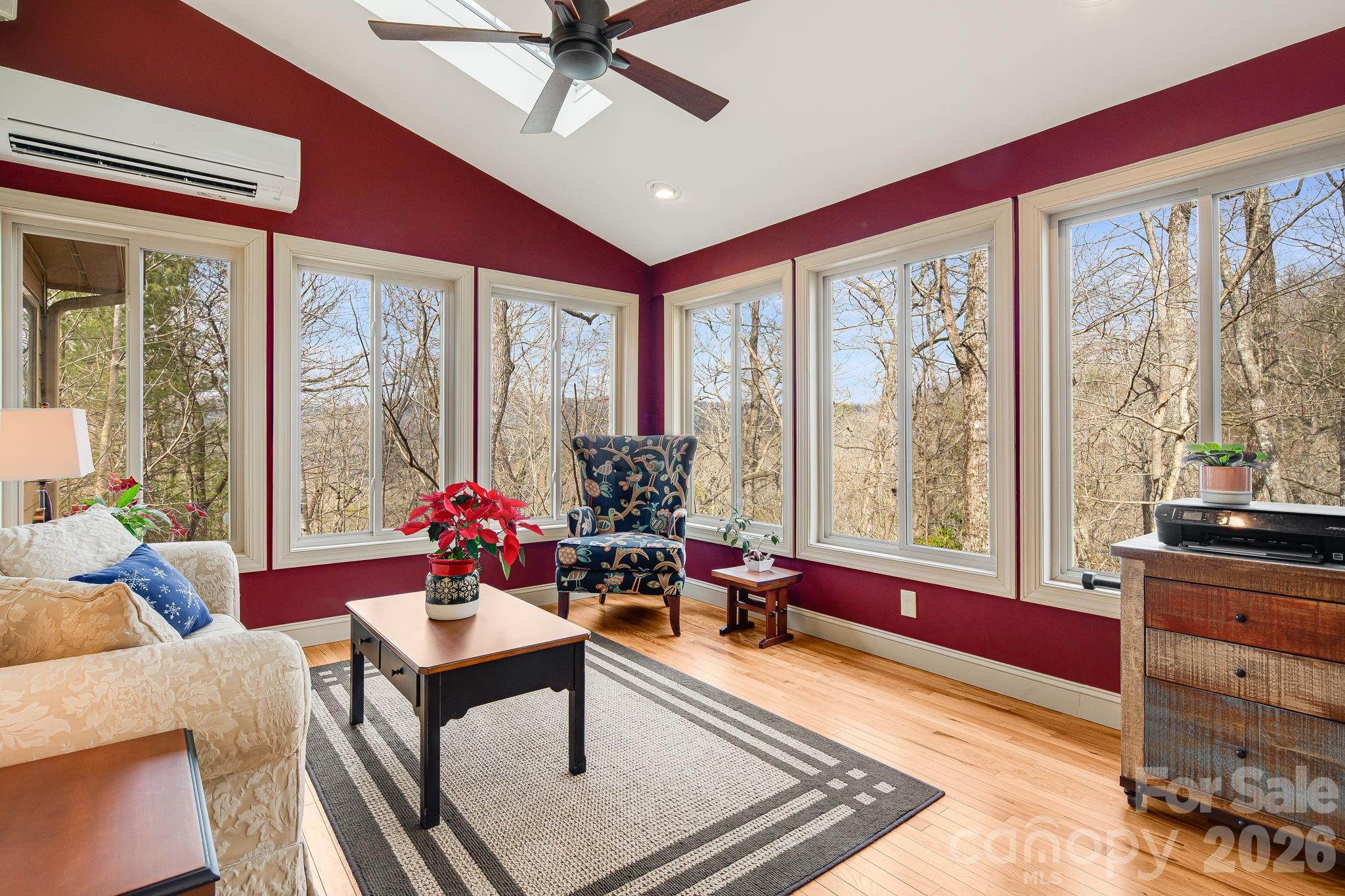5584 Spring Road Hendersonville, NC 28739 - Photo 21 of 45 a living room with furniture and a floor to ceiling window