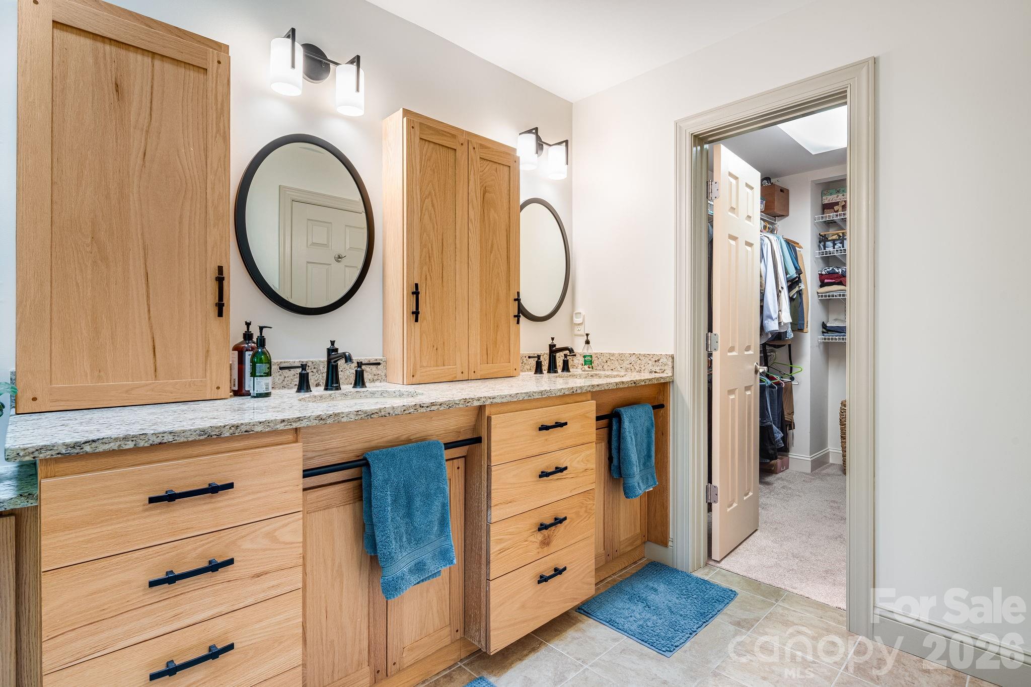 5584 Spring Road Hendersonville, NC 28739 - Photo 25 of 45 a bathroom with a double vanity sink and a mirror