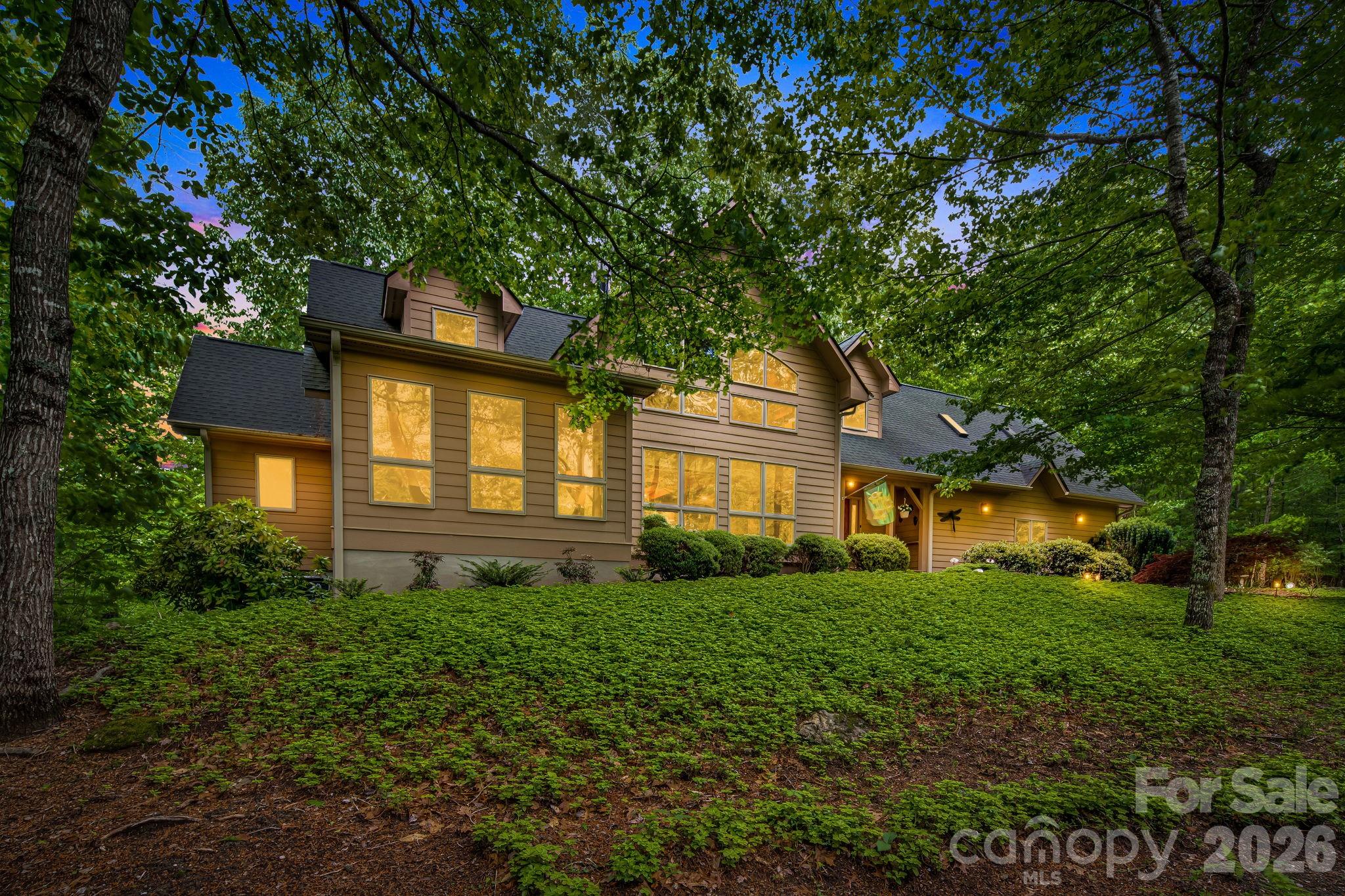 5584 Spring Road Hendersonville, NC 28739 - Photo 3 of 45 a view of a house with a large tree