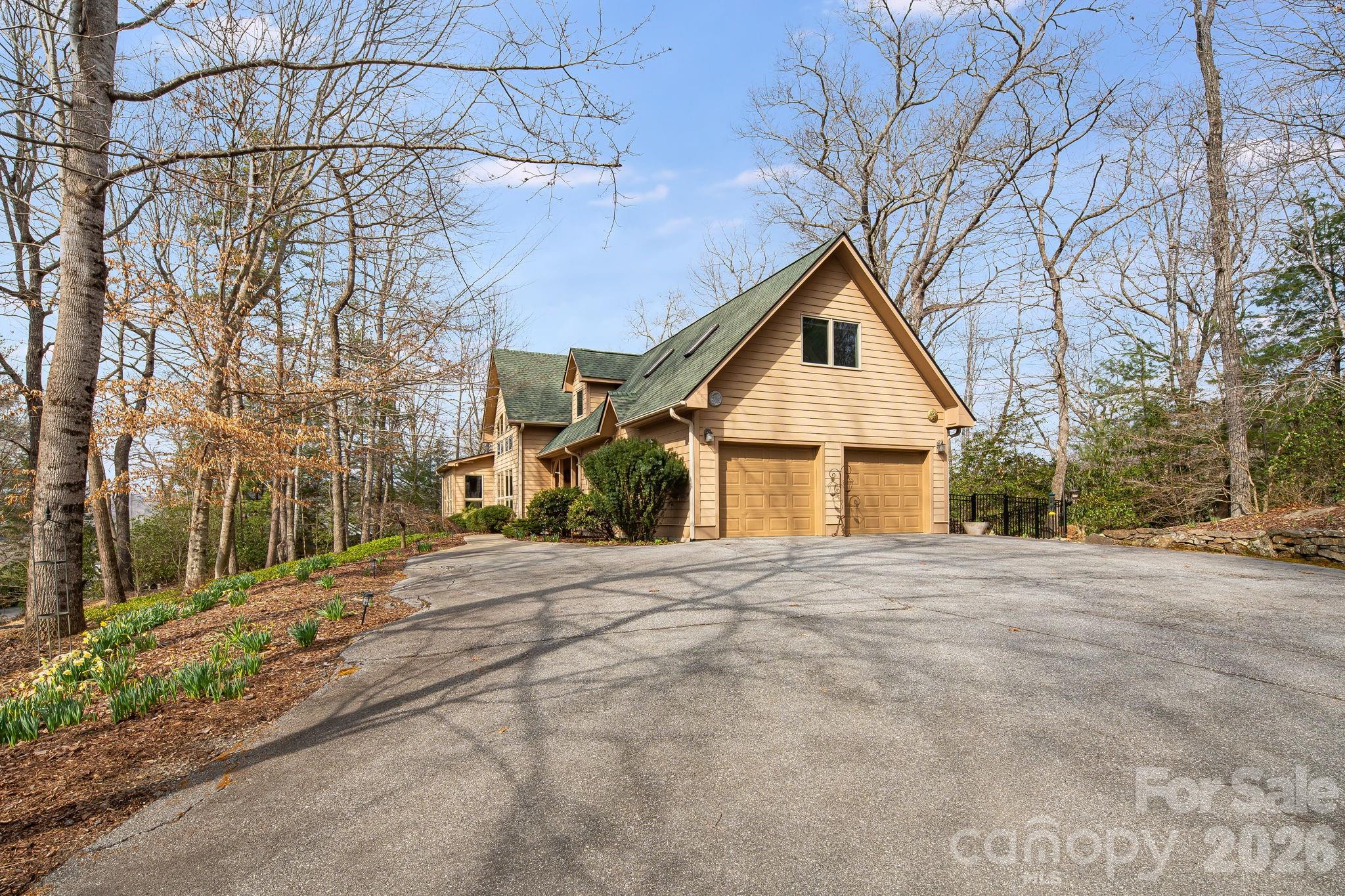 5584 Spring Road Hendersonville, NC 28739 - Photo 7 of 45 a front view of a house with a yard and garage