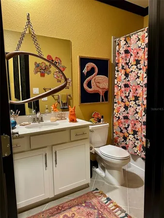 a bathroom with a sink toilet and mirror