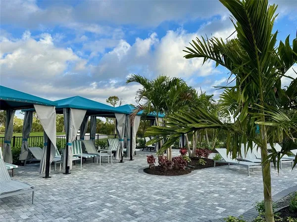 a view of a chair and tables in the patio