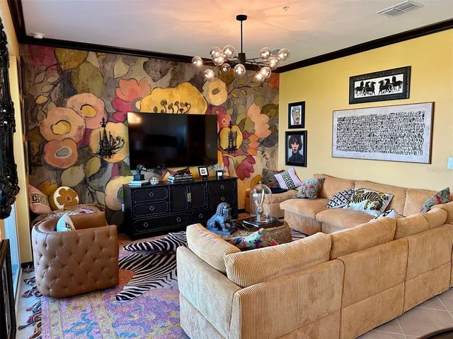 a living room with furniture a flat screen tv and a flat screen tv