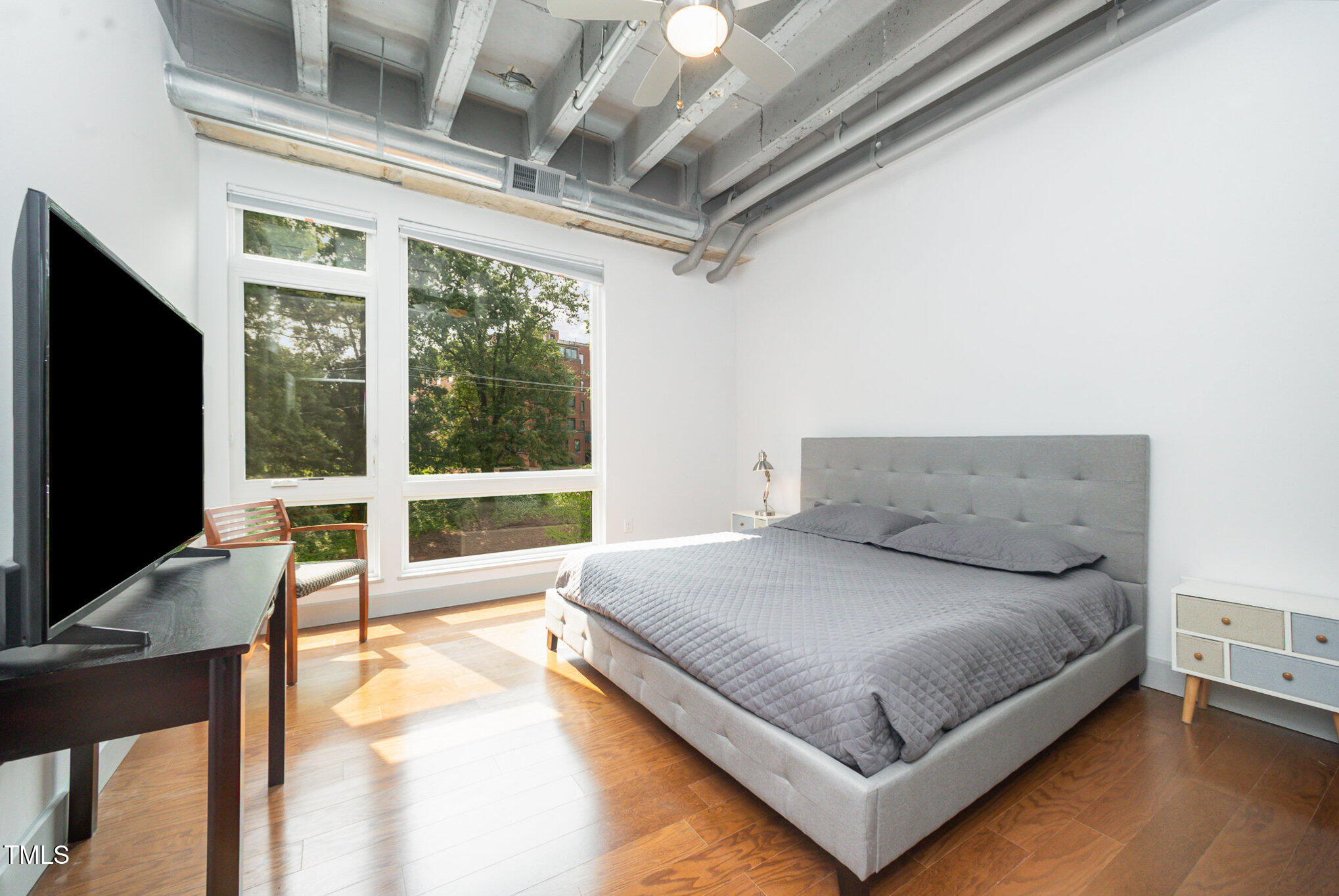 1300 St Marys Street, Unit 408 Raleigh, NC 27605 - Photo 11 of 28 a bedroom with a bed and glass window
