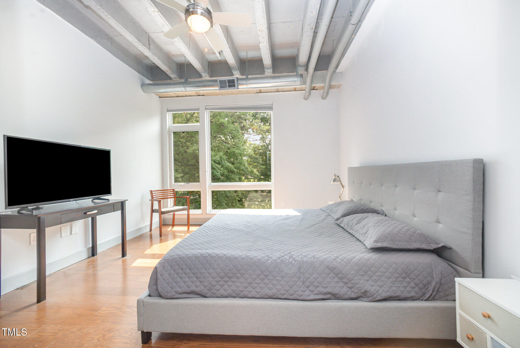 1300 St Marys Street, Unit 408 Raleigh, NC 27605 - Photo 12 of 28 a bedroom with a bed and a flat screen tv