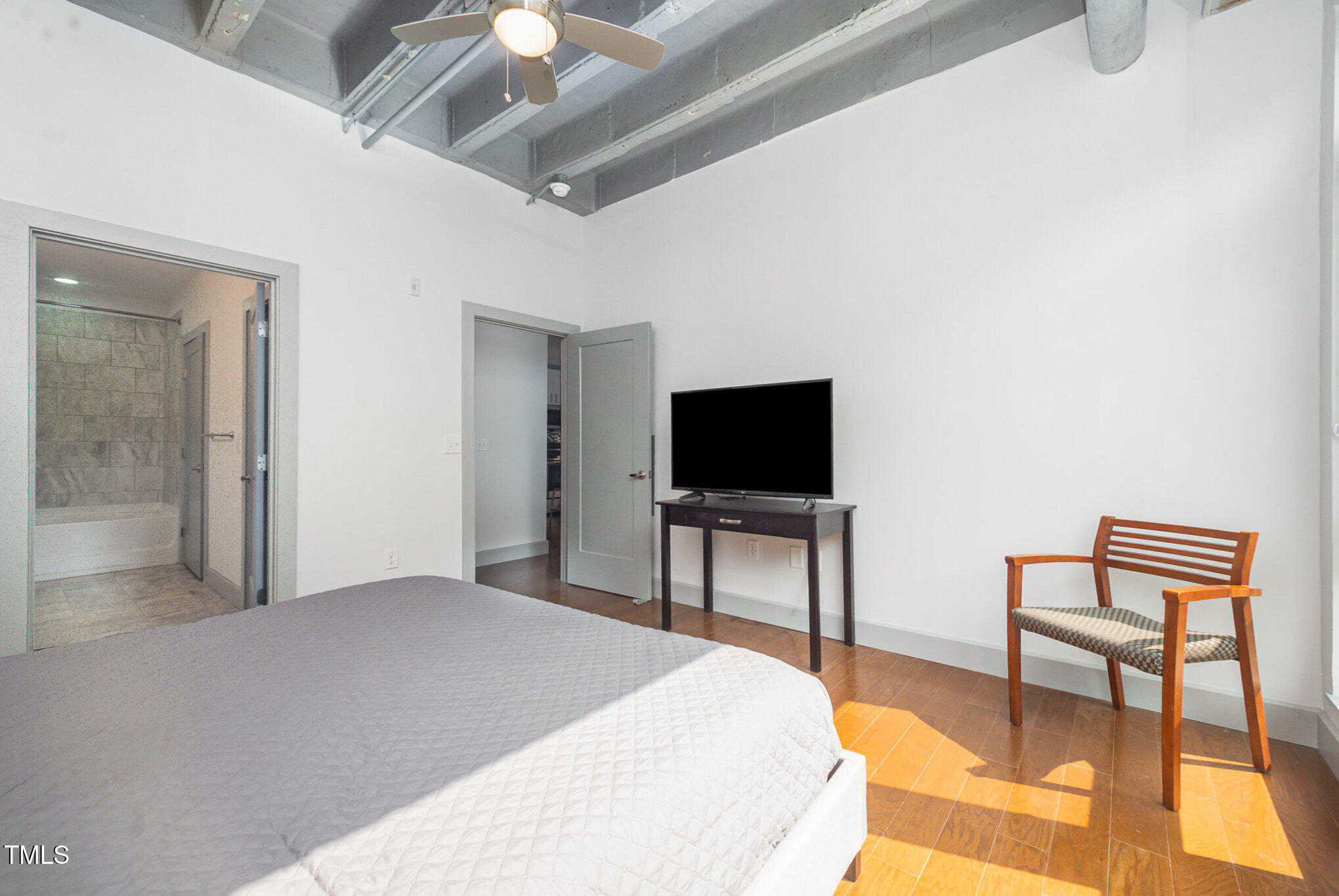 1300 St Marys Street, Unit 408 Raleigh, NC 27605 - Photo 13 of 28 a bedroom with a bed and a flat screen tv