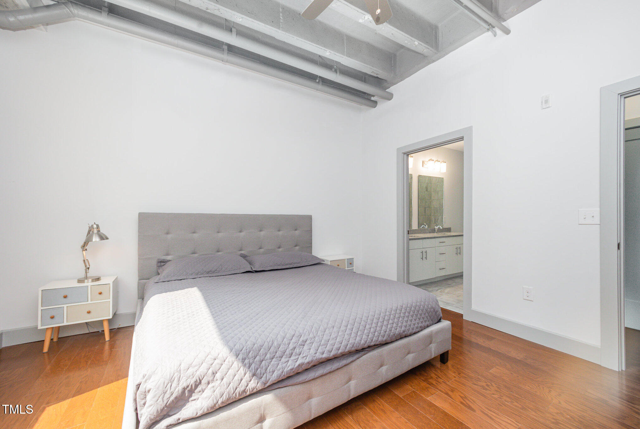 1300 St Marys Street, Unit 408 Raleigh, NC 27605 - Photo 14 of 28 a bedroom with a bed and a table