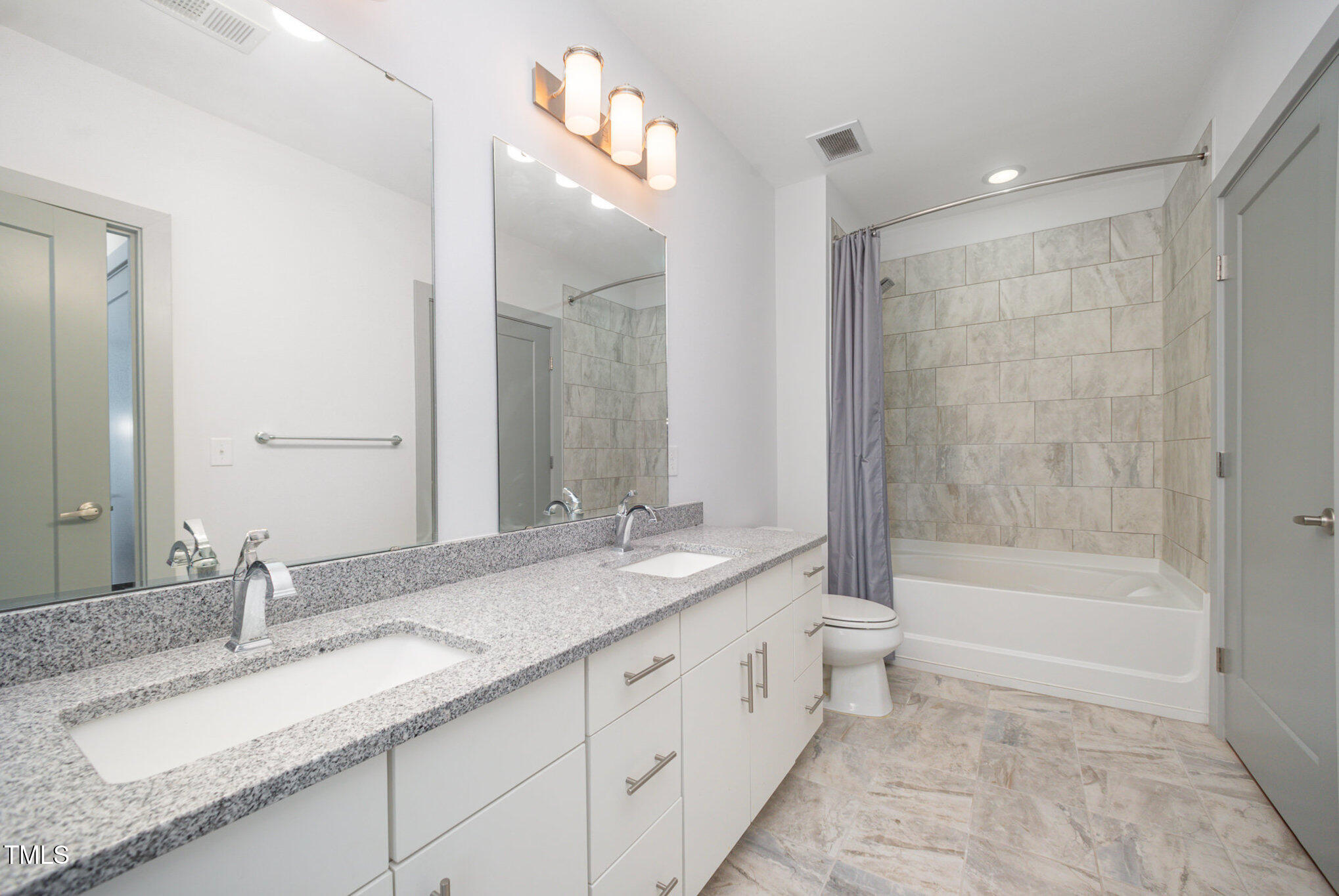 1300 St Marys Street, Unit 408 Raleigh, NC 27605 - Photo 16 of 28 a bathroom with a granite countertop sink mirror and a
