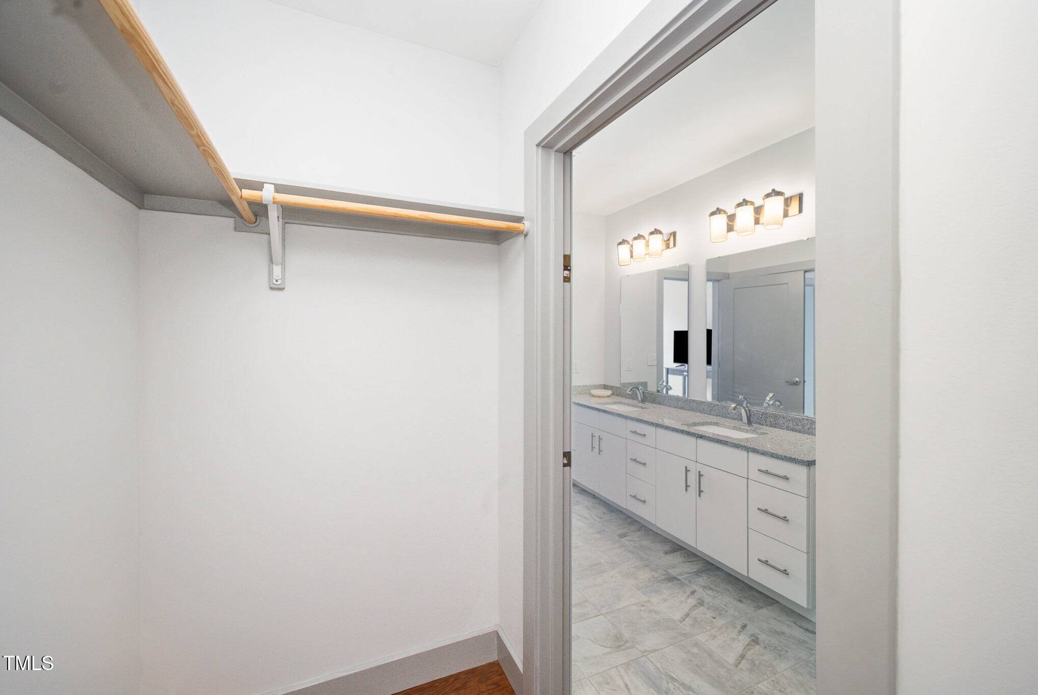 1300 St Marys Street, Unit 408 Raleigh, NC 27605 - Photo 20 of 28 a bathroom with a granite countertop sink and a mirror