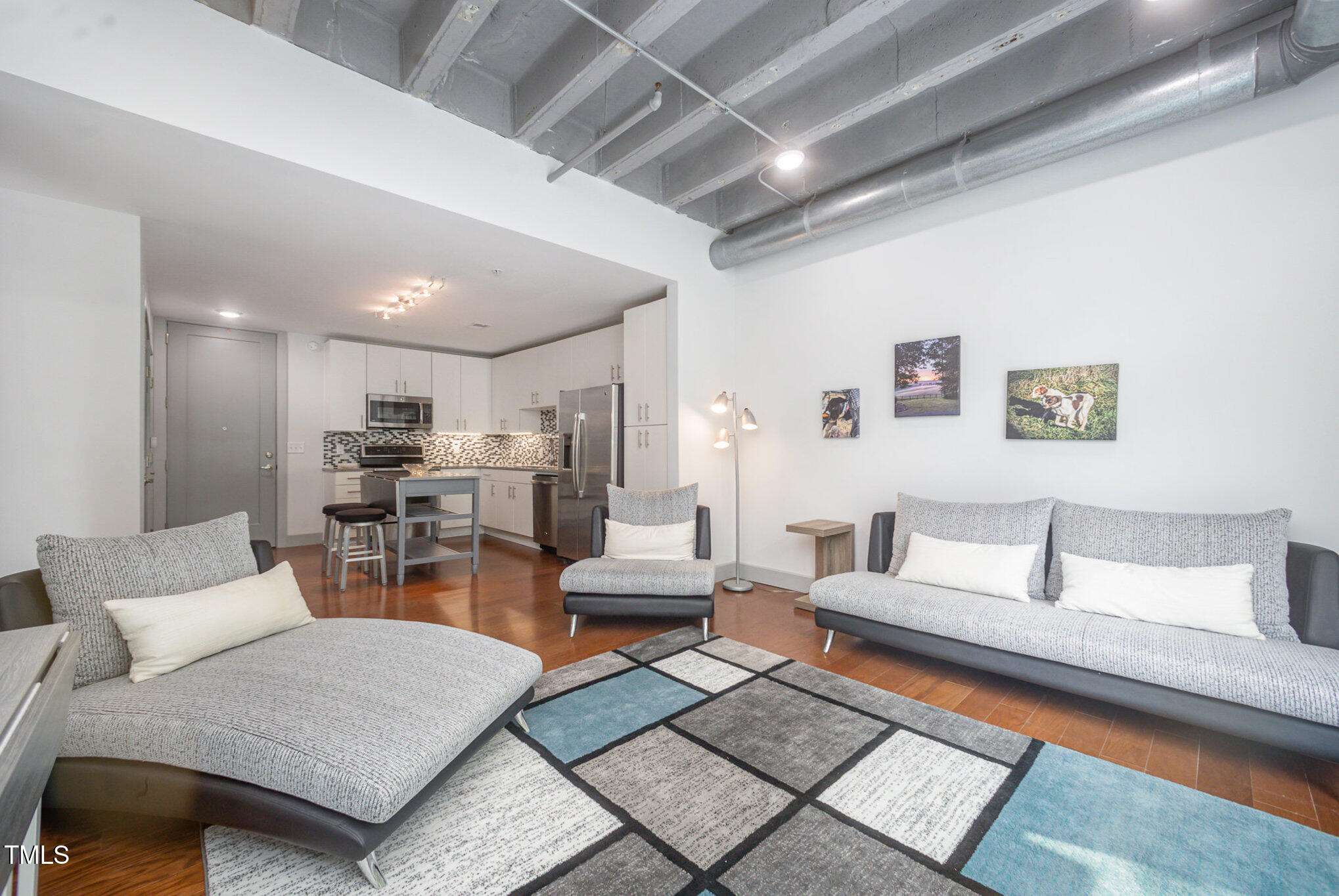 1300 St Marys Street, Unit 408 Raleigh, NC 27605 - Photo 2 of 28 a living room with furniture and view of kitchen