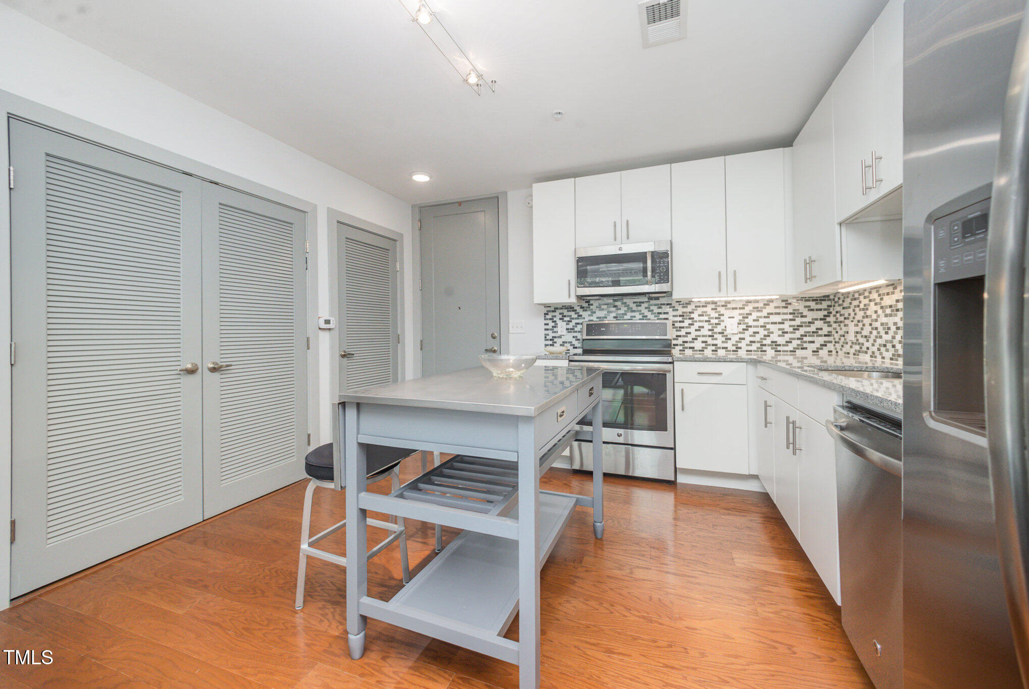 1300 St Marys Street, Unit 408 Raleigh, NC 27605 - Photo 7 of 28 a kitchen with stainless steel appliances a stove a sink and a refrigerator
