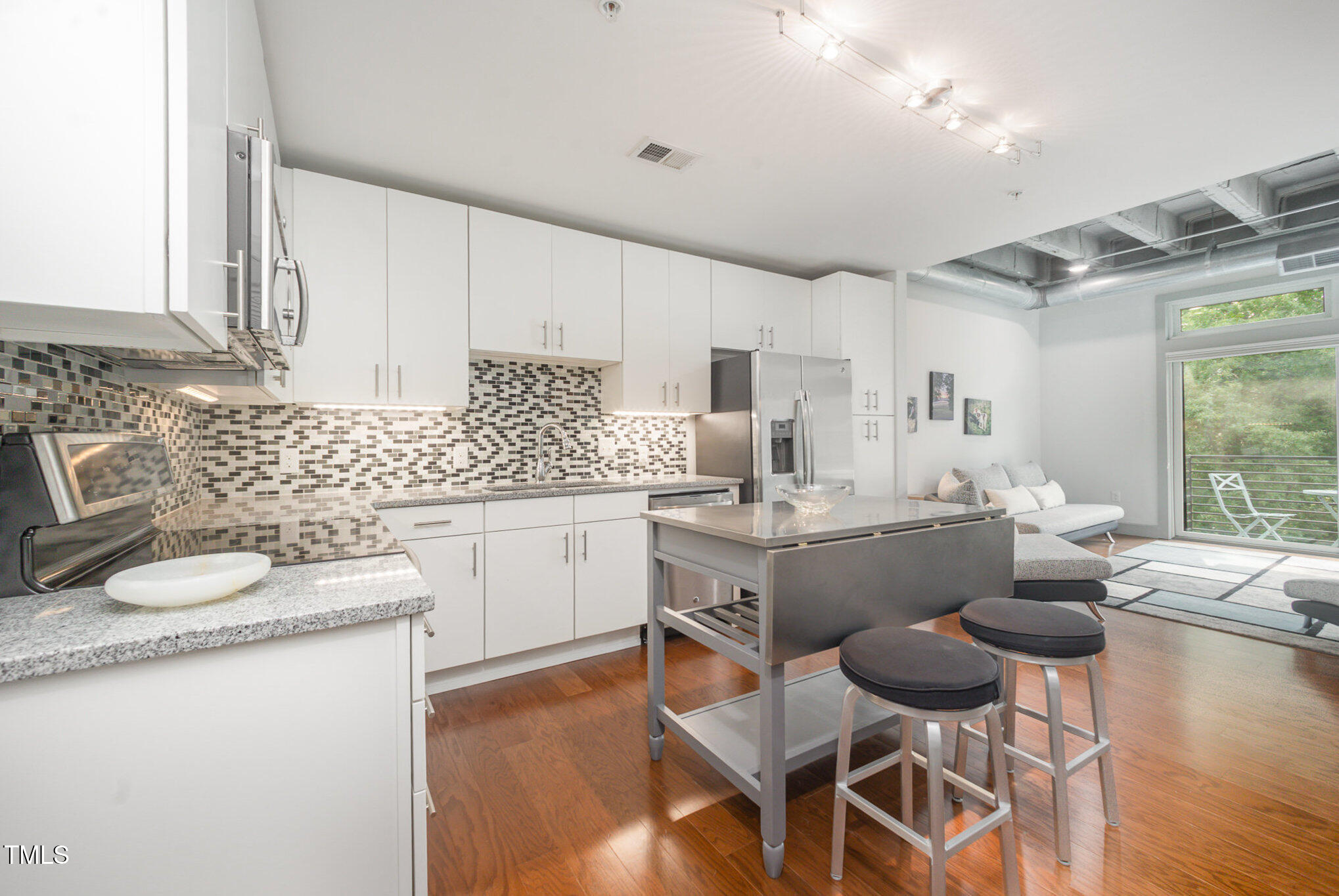 1300 St Marys Street, Unit 408 Raleigh, NC 27605 - Photo 8 of 28 a kitchen with sink cabinets and wooden floor