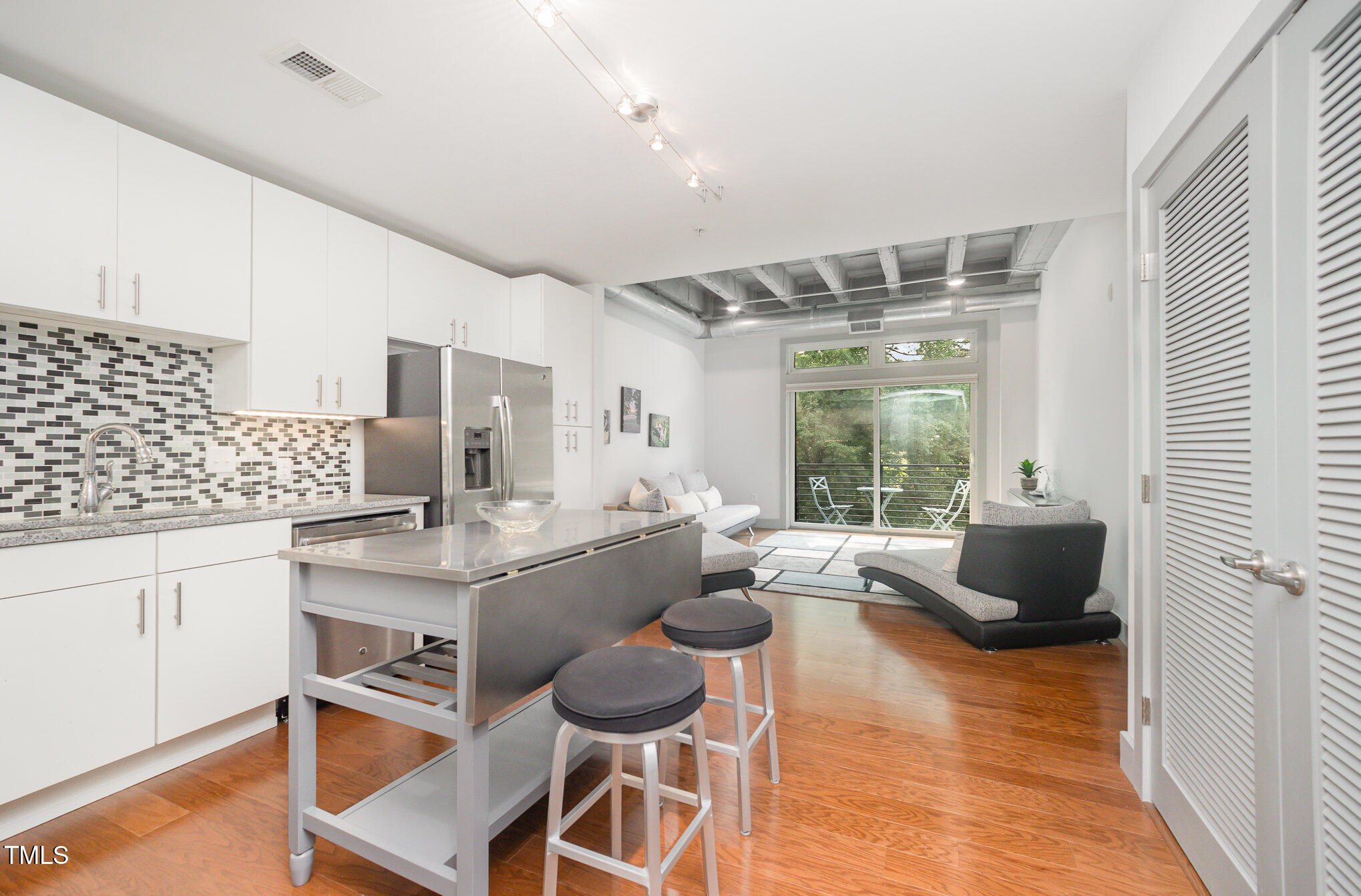 1300 St Marys Street, Unit 408 Raleigh, NC 27605 - Photo 9 of 28 a living room with furniture and a large window