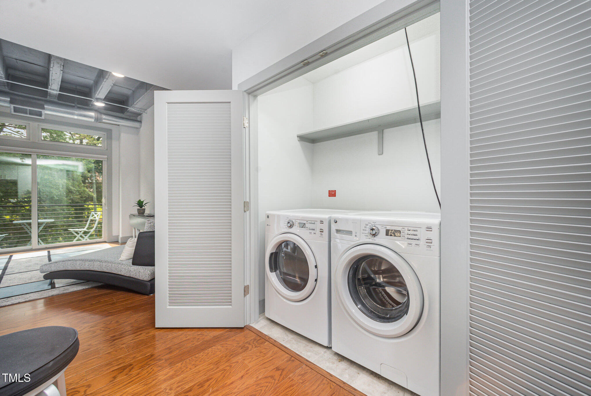 1300 St Marys Street, Unit 408 Raleigh, NC 27605 - Photo 10 of 28 a view of washer and dryer with bathroom in the background