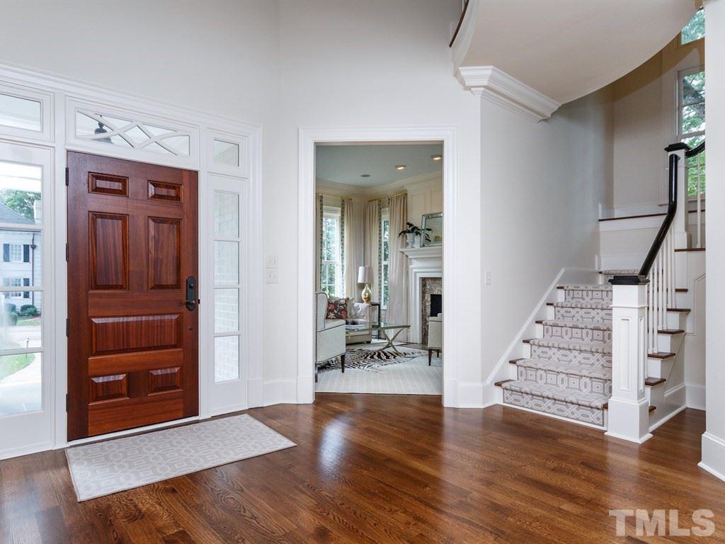 2305 Beechridge Road Raleigh, NC 27608 - Photo 3 of 24 wooden floor in an empty room with a mirror