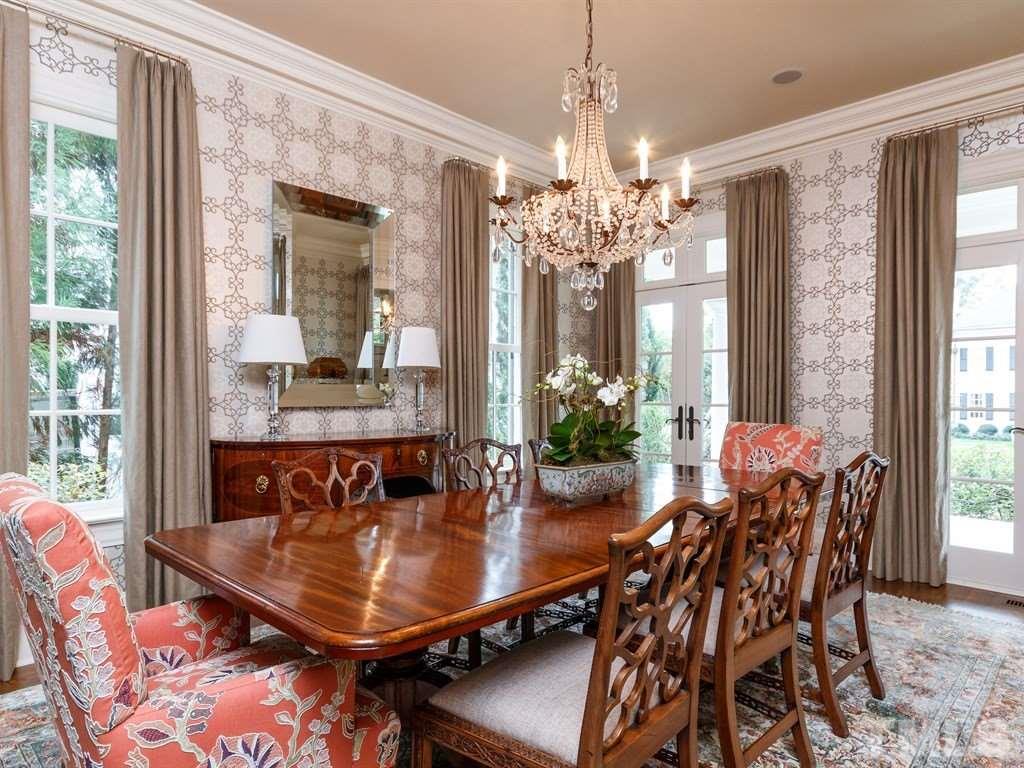2305 Beechridge Road Raleigh, NC 27608 - Photo 5 of 24 a dining room with furniture a chandelier and wooden floor