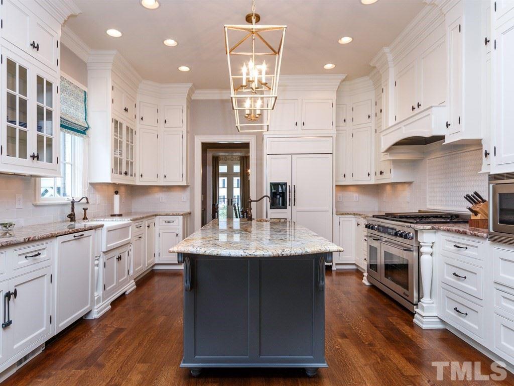 2305 Beechridge Road Raleigh, NC 27608 - Photo 7 of 24 a kitchen with stainless steel appliances granite countertop a stove a sink dishwasher and a refrigerator with wooden floor